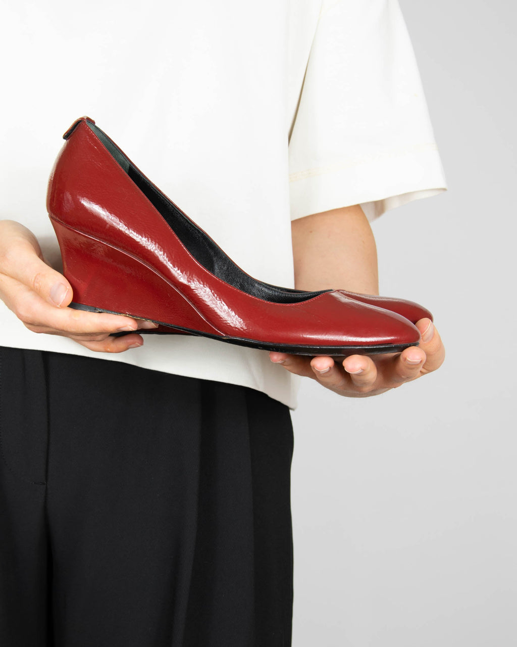 Red leather wedge pumps by Gucci