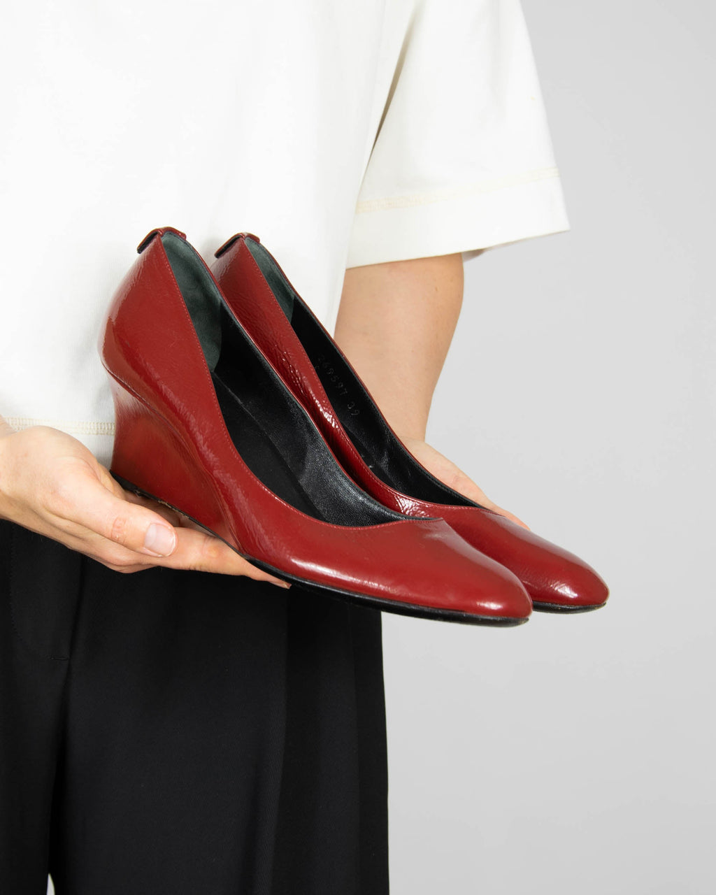 Red leather wedge pumps by Gucci