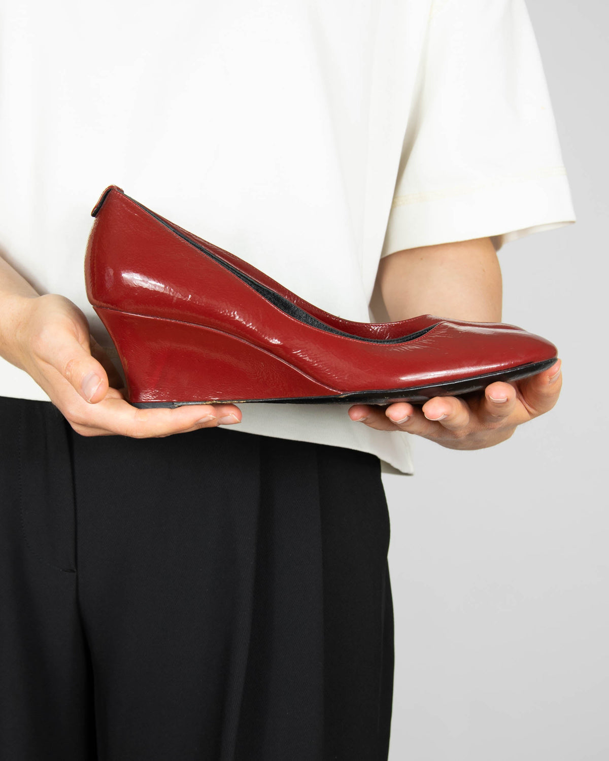 Red leather wedge pumps by Gucci