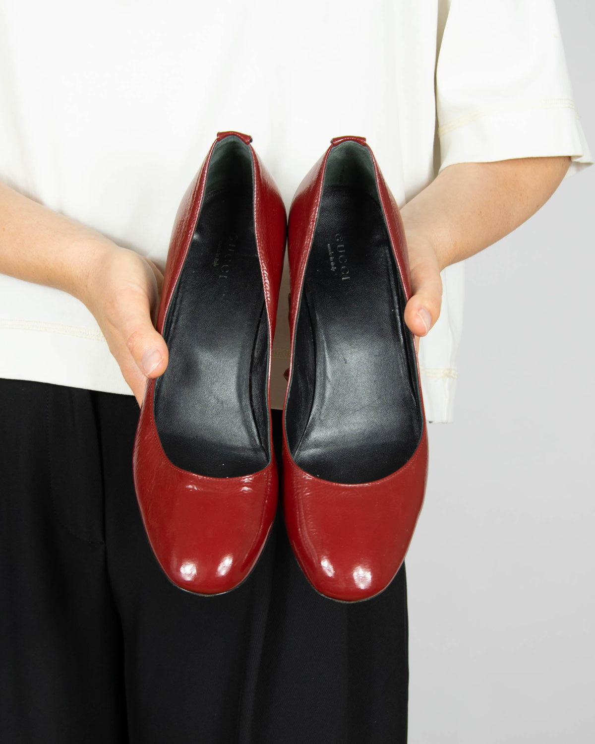 Red leather wedge pumps by Gucci