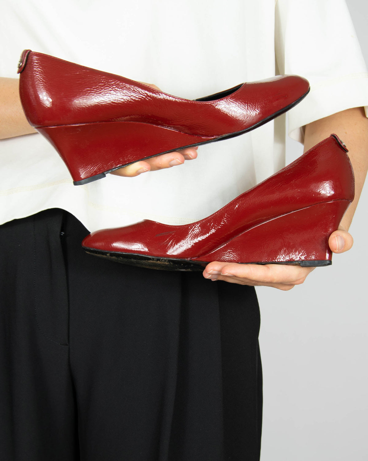 Red leather wedge pumps by Gucci