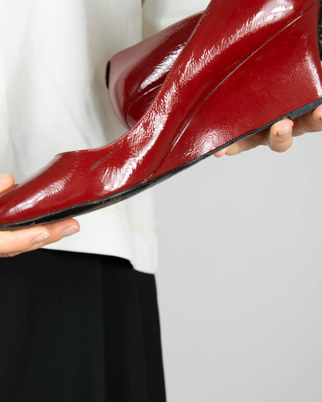 Red leather wedge pumps by Gucci