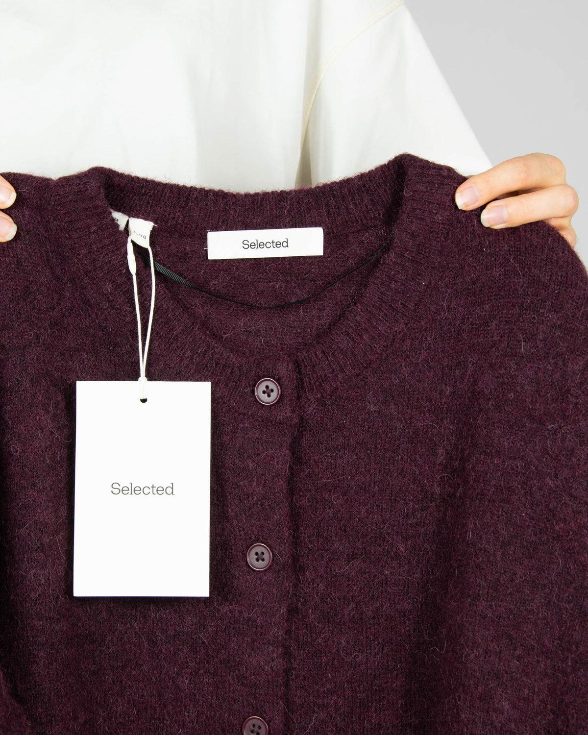 Burgundy wool and alpaca cardigan by Scandinavian brand Selected. The price on the tag is 330 PLN.