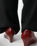 Red leather wedge pumps by Gucci