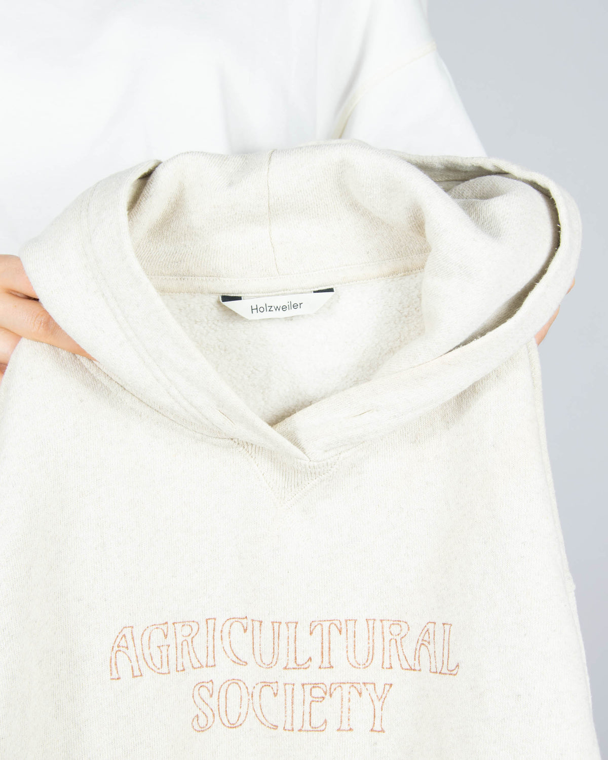 Beige hoodie made from organic cotton and hemp by Norwegian designer brand Holzweiler. The regular price is 3500 NOK (~1370 PLN). Made in Portugal.