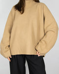 Beige boiled merino wool turtleneck sweater by COS.