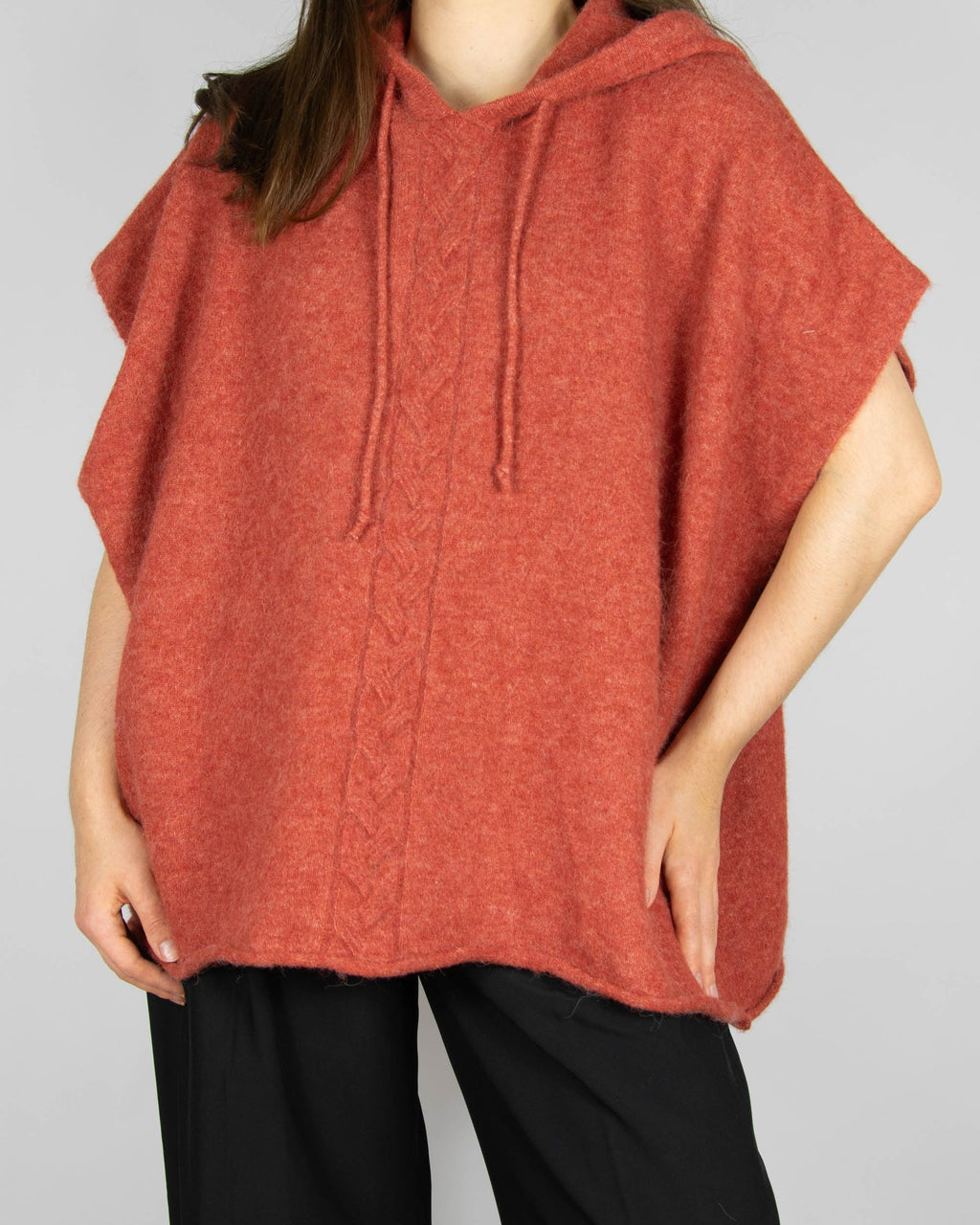 Coral alpaca and merino wool hooded poncho by Scandinavian brand RAH Oslo.