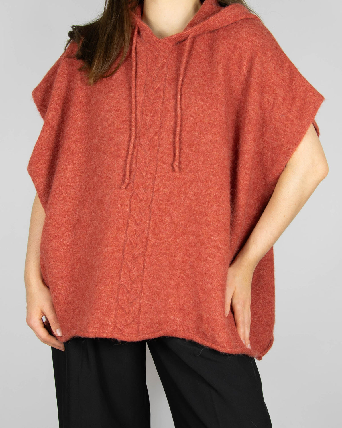 Coral alpaca and merino wool hooded poncho by Scandinavian brand RAH Oslo.