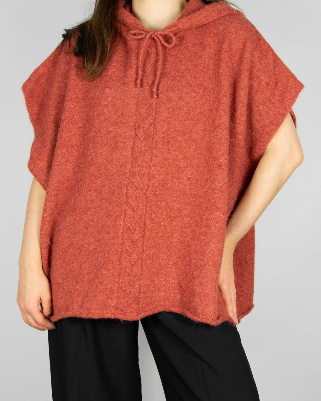 Coral alpaca and merino wool hooded poncho by Scandinavian brand RAH Oslo.