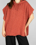 Coral alpaca and merino wool hooded poncho by Scandinavian brand RAH Oslo.
