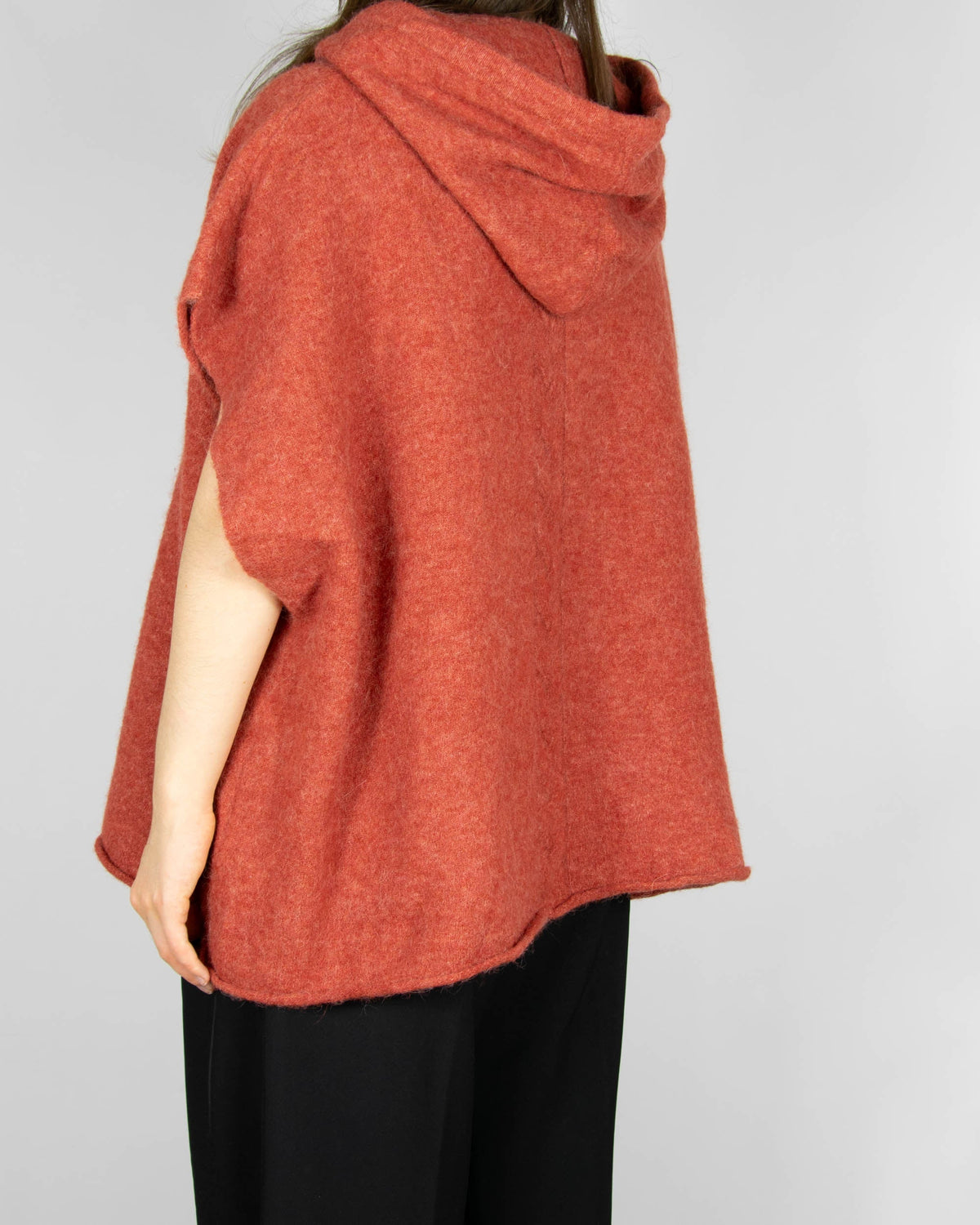 Coral alpaca and merino wool hooded poncho by Scandinavian brand RAH Oslo.