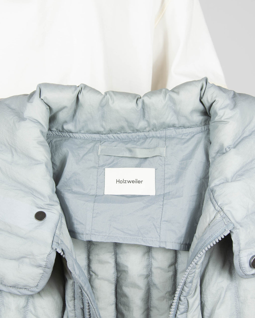 Grey down vest by premium brand Holzweiler. The regular price is €300 (~1300 PLN).