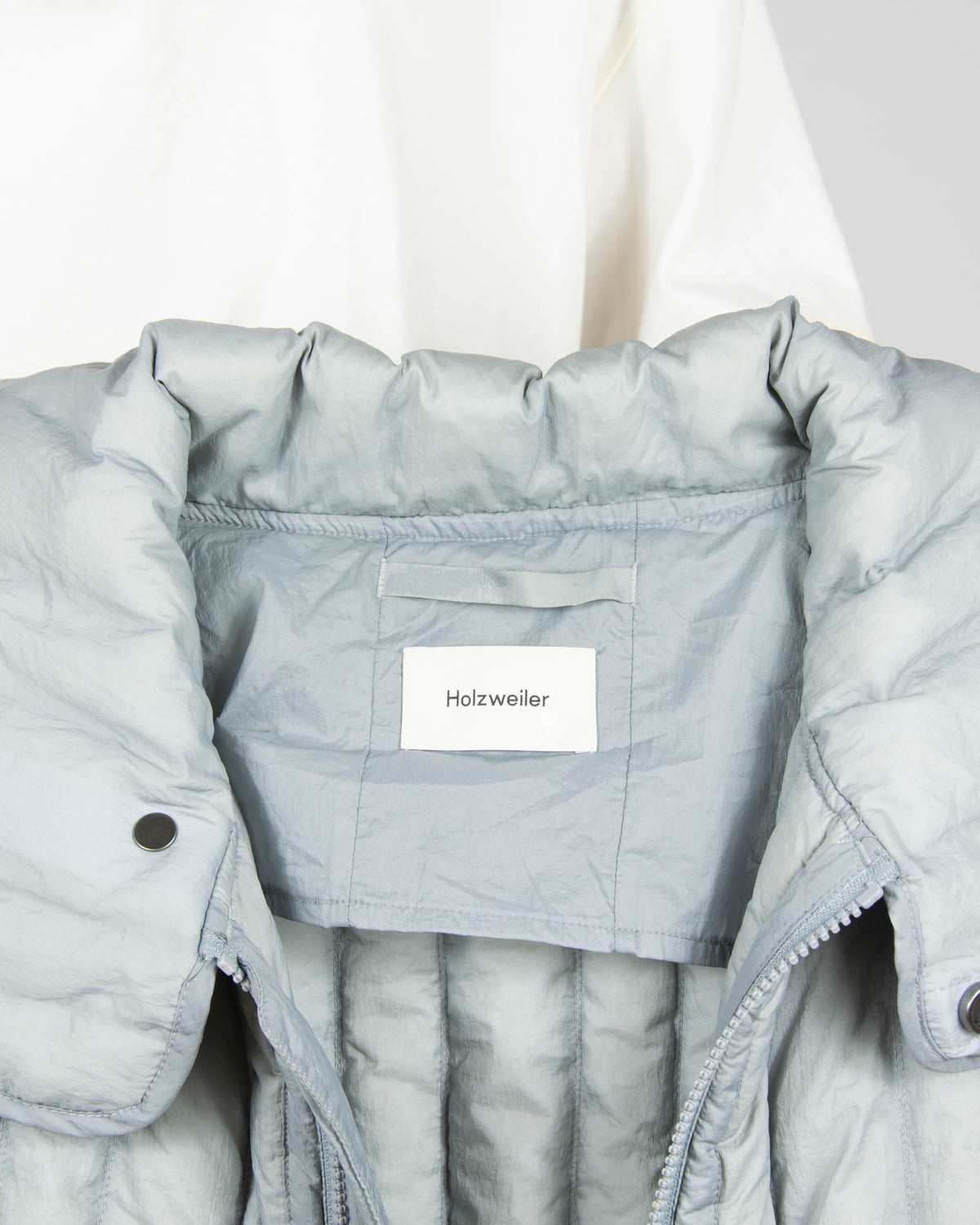 Grey down vest by premium brand Holzweiler. The regular price is €300 (~1300 PLN).